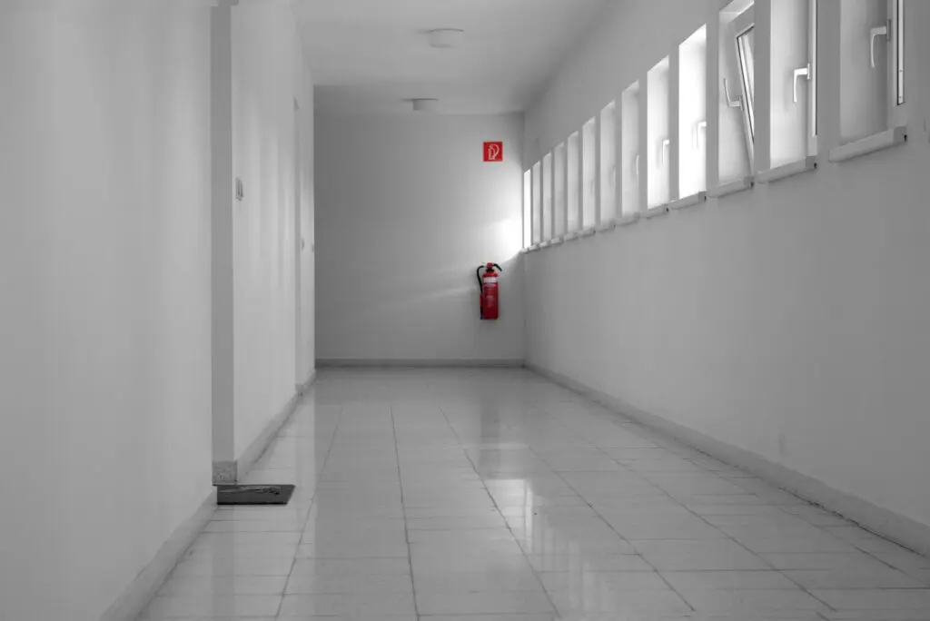 Fire safety in supported accommodation: a fire extinguisher in a clear communal corridor