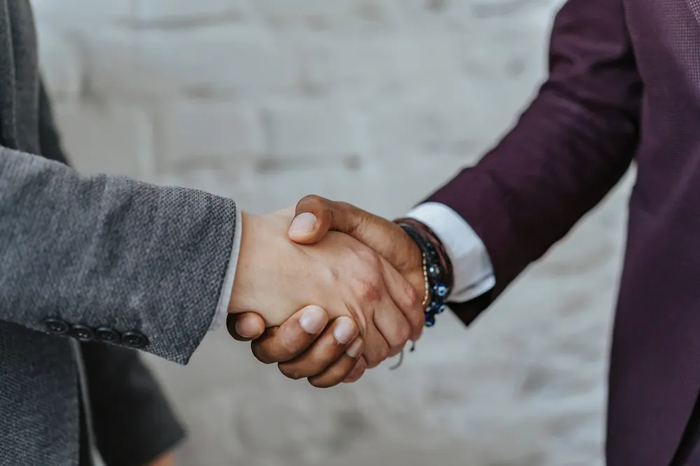 Two people shaking hands to confirm a partnership